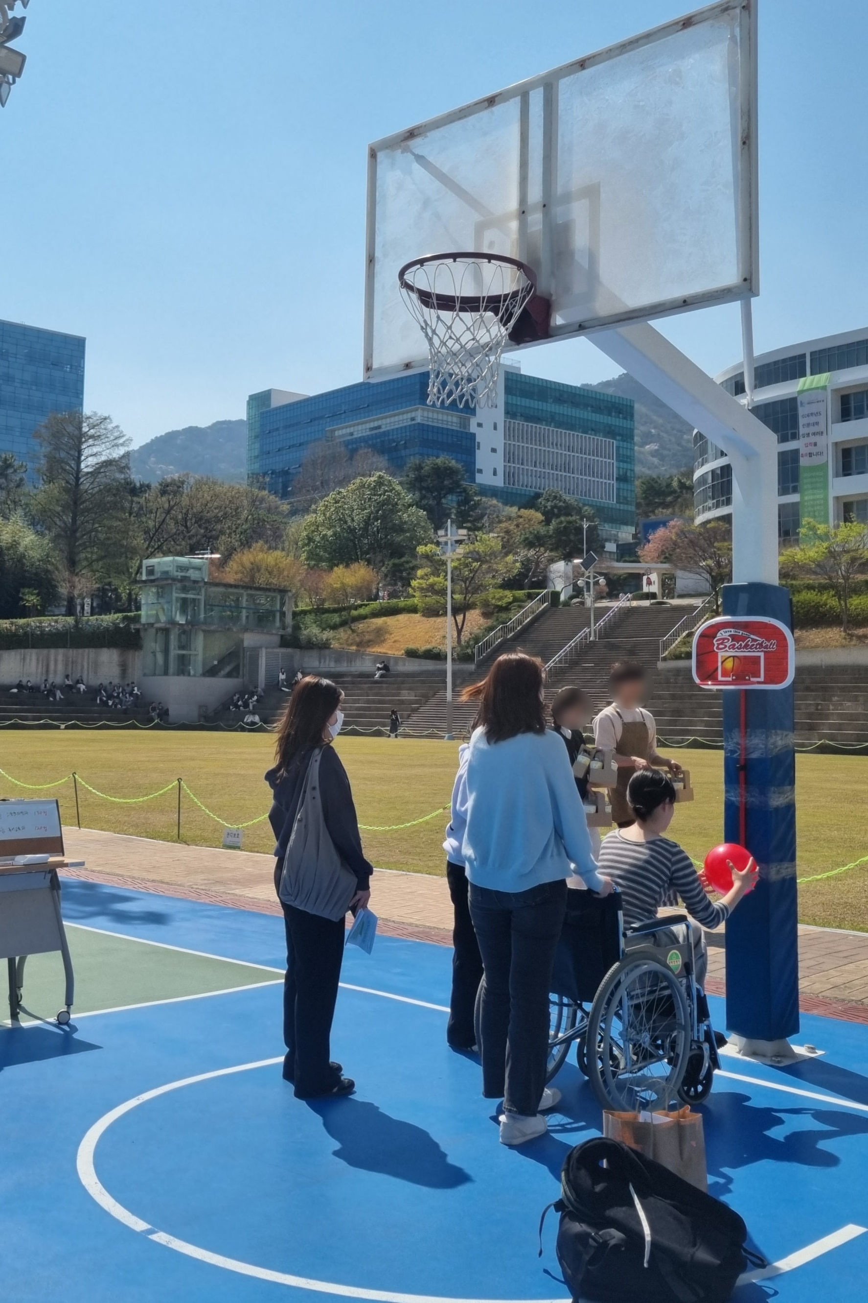 장애인스포츠존에서 휠체어를 타고 농구를 체험하고 있다.